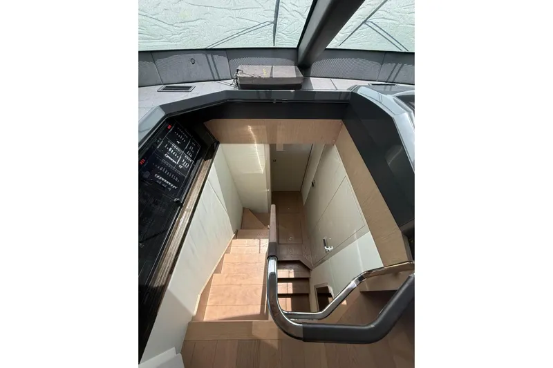 3775 Yacht Photos Pics Interior staircase of 2019 Absolute 62 Fly yacht, featuring modern design and wood finish.