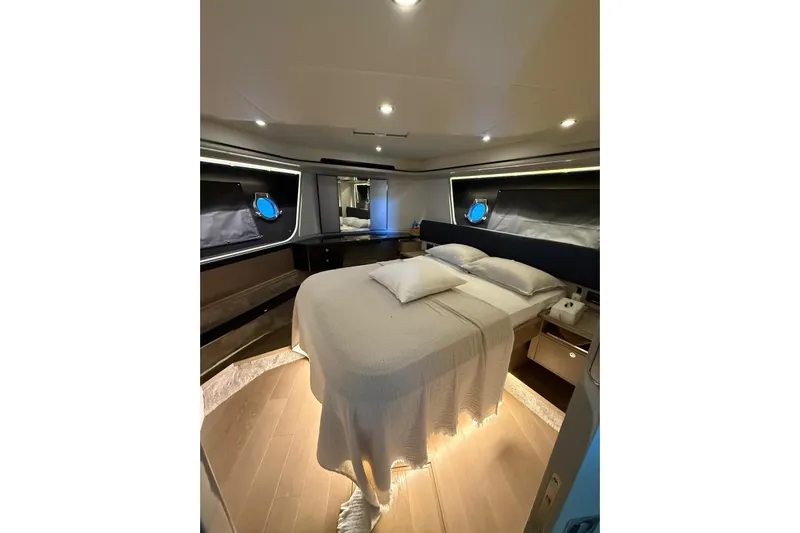 3775 Yacht Photos Pics Luxurious bedroom interior of 2019 Absolute 62 Fly yacht, featuring elegant lighting and modern design.