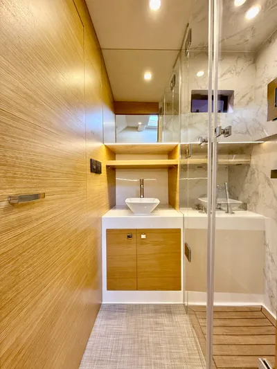  Yacht Photos Pics Luxurious bathroom interior of 2023 De Antonio Yachts D50 Coup&eacute; with modern fixtures and wood accents.