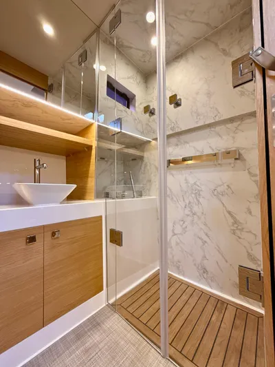  Yacht Photos Pics Luxurious bathroom in 2023 De Antonio Yachts D50 Coup&eacute; with modern fixtures and marble accents.