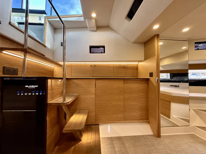  Yacht Photos Pics Modern interior of 2023 De Antonio Yachts D50 Coup&eacute;, featuring sleek wood finishes and ambient lighting.