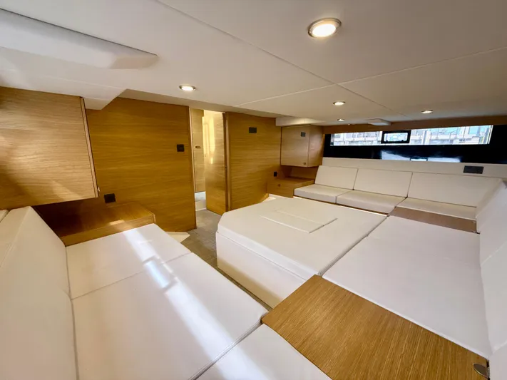  Yacht Photos Pics Luxurious interior of 2023 De Antonio Yachts D50 Coup&eacute; with modern wood and white furnishings.