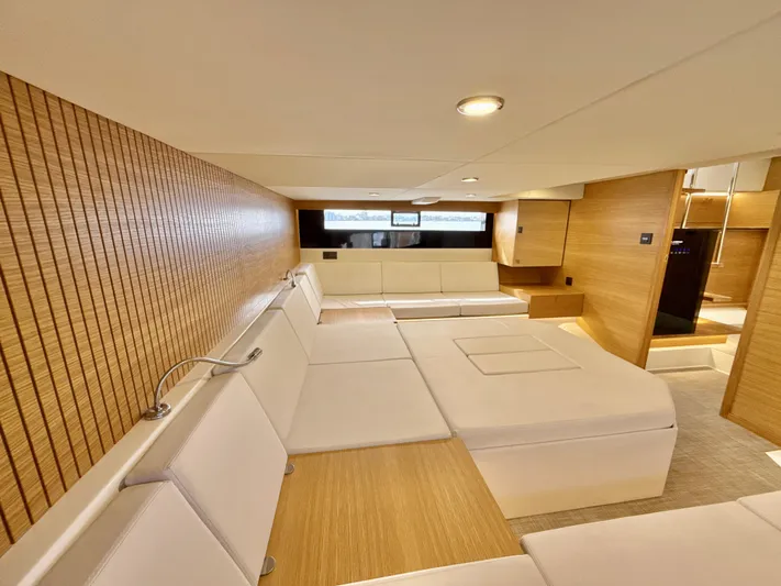  Yacht Photos Pics Luxurious interior of 2023 De Antonio Yachts D50 Coup&eacute; with modern wood paneling and plush seating.