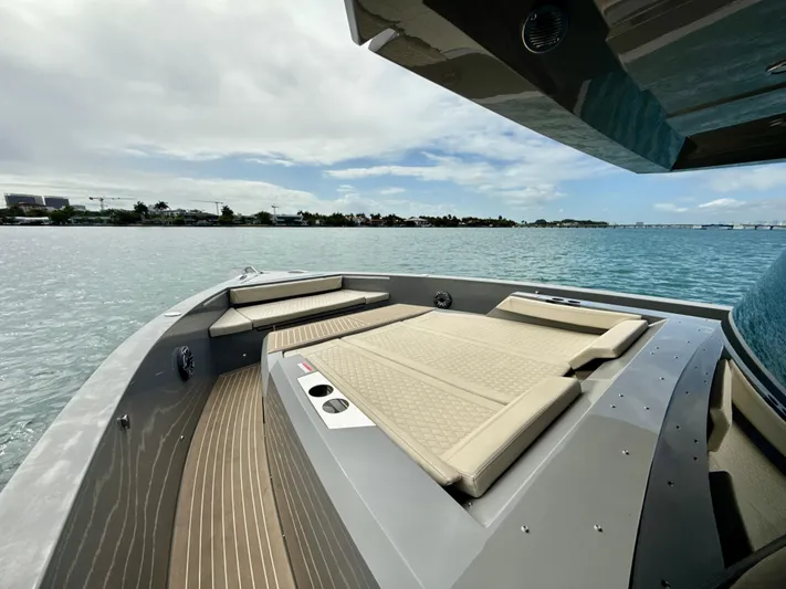  Yacht Photos Pics 2023 De Antonio Yachts D50 Coup&eacute;, luxurious deck view on serene water.