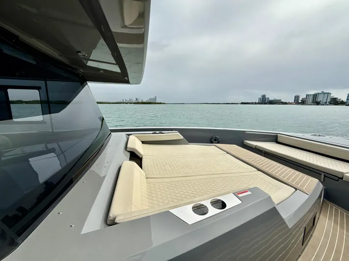  Yacht Photos Pics 2023 De Antonio Yachts D50 Coup&eacute; with luxurious deck seating, overlooking a serene waterfront.