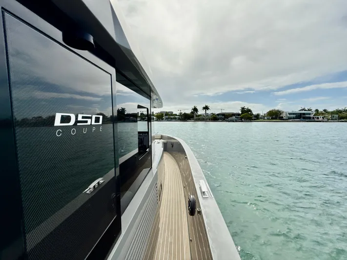  Yacht Photos Pics 2023 De Antonio Yachts D50 Coup&eacute; on serene water, showcasing sleek design and luxury.
