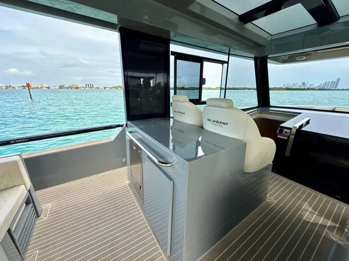 Yacht Photos Pics 2023 De Antonio Yachts D50 Coup&eacute; interior with modern design and waterfront view.