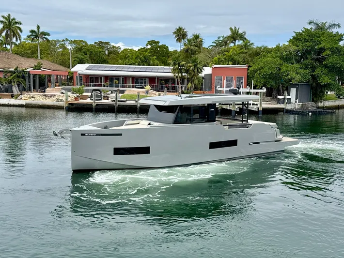  Yacht Photos Pics 2023 De Antonio Yachts D50 Coup&eacute; cruising in a scenic waterfront setting.