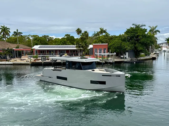  Yacht Photos Pics 2023 De Antonio Yachts D50 Coup&eacute; cruising in a scenic waterfront setting.