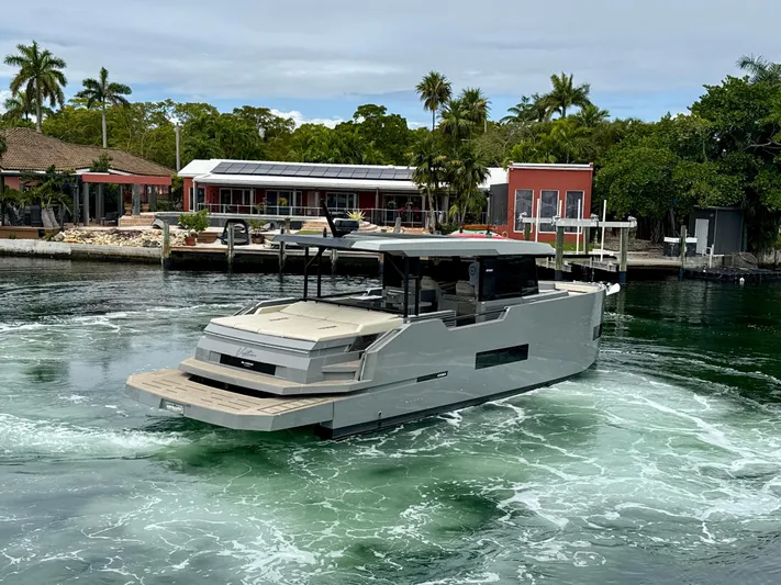  Yacht Photos Pics 2023 De Antonio Yachts D50 Coup&eacute; cruising in a scenic waterfront setting.