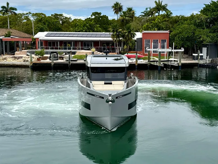  Yacht Photos Pics 2023 De Antonio Yachts D50 Coup&eacute; in a serene marina setting.