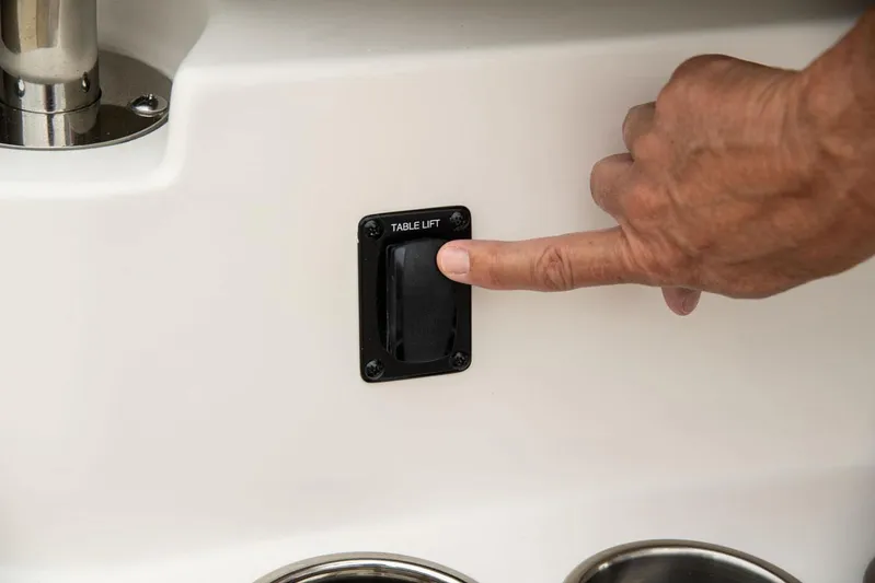  Yacht Photos Pics Finger pressing table lift switch on Sailfish 360 CC boat, 2022 model.