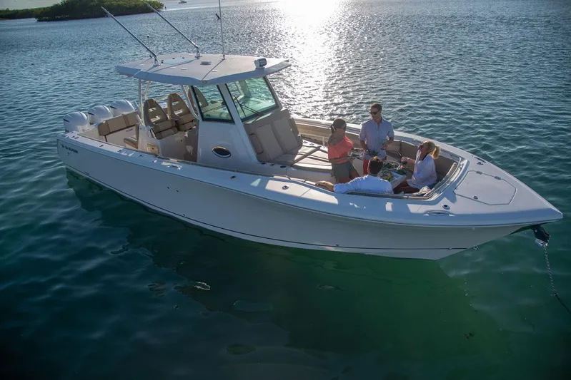  Yacht Photos Pics Sailfish 360 CC 2022 boat on calm water with passengers.