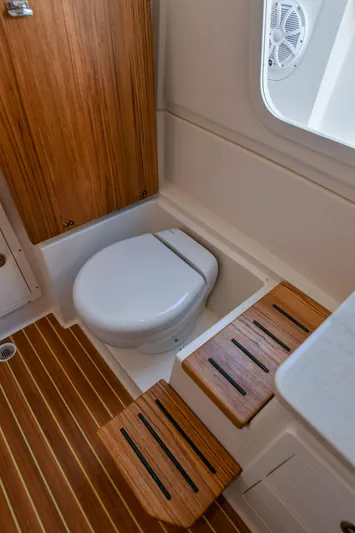  Yacht Photos Pics Interior of 2022 Sailfish 360 CC with toilet and wooden flooring.