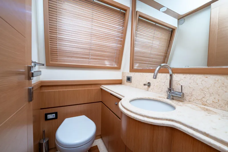 La Luce Yacht Photos Pics Luxurious bathroom in 2008 Custom Line Navetta 26 yacht with modern fixtures and wooden accents.