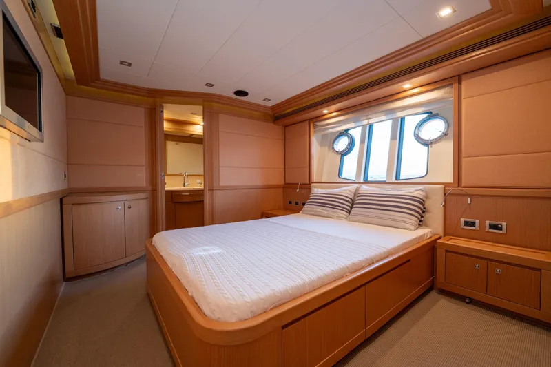 La Luce Yacht Photos Pics Luxurious bedroom interior on 2008 Custom Line Navetta 26 yacht, featuring elegant wood finishes.