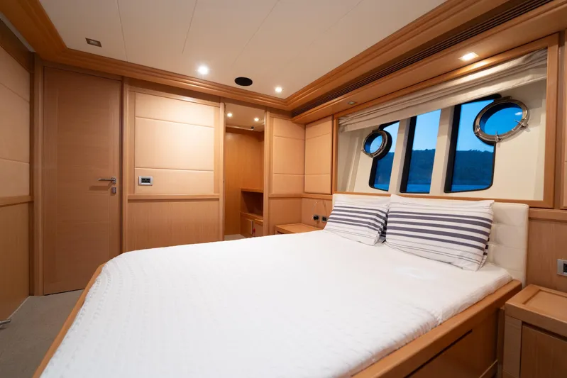 La Luce Yacht Photos Pics Luxurious bedroom interior on 2008 Custom Line Navetta 26 yacht with porthole windows.