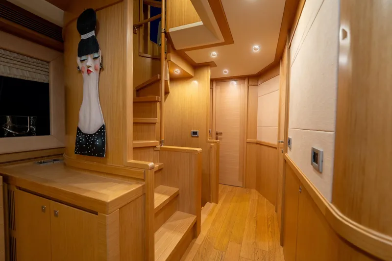 La Luce Yacht Photos Pics Luxurious interior of 2008 Custom Line Navetta 26 yacht with wooden finishes and unique wall art.