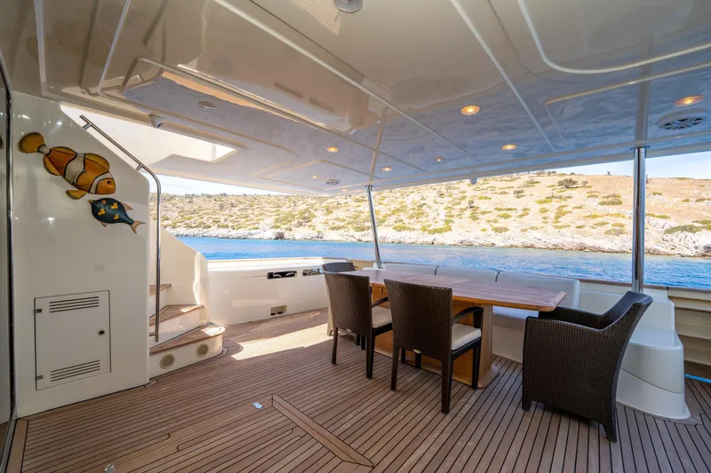 La Luce Yacht Photos Pics Luxurious 2008 Custom Line Navetta 26 yacht deck with dining area and scenic ocean view.