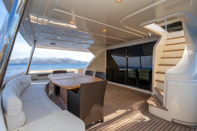 La Luce Yacht Photos Pics Luxurious 2008 Custom Line Navetta 26 yacht deck with seating, table, and ocean view.