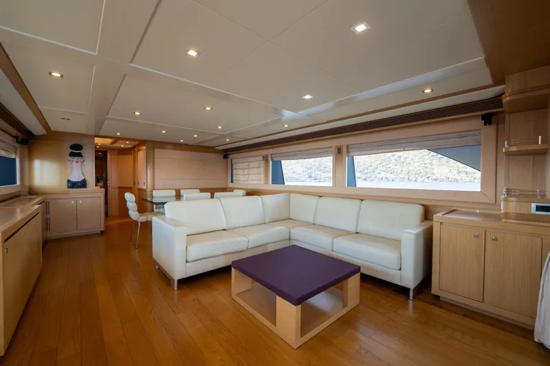 La Luce Yacht Photos Pics Luxurious interior of 2008 Custom Line Navetta 26 yacht with white sofa and wooden decor.
