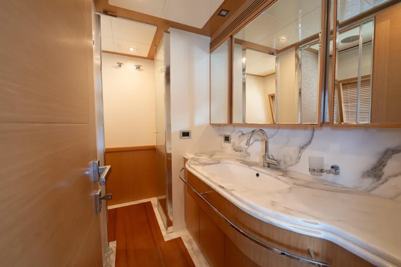 La Luce Yacht Photos Pics Luxurious bathroom interior on 2008 Custom Line Navetta 26 yacht, featuring marble countertops and wood accents.