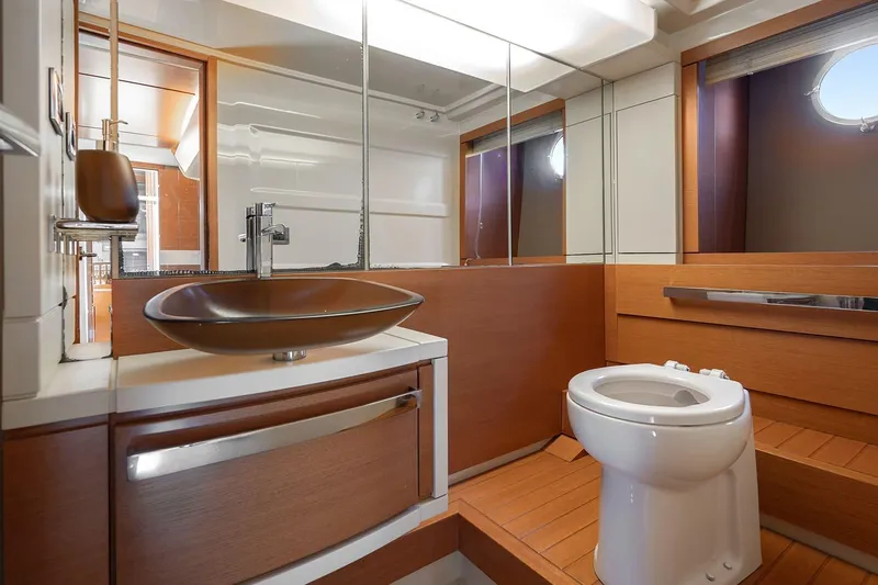Elena I Yacht Photos Pics Luxurious bathroom interior of 2013 Azimut 64 yacht with modern fixtures and wooden accents.