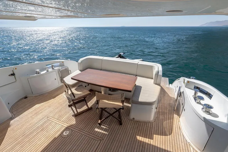 Elena I Yacht Photos Pics Luxurious 2013 Azimut 64 yacht deck with seating, overlooking serene ocean view.