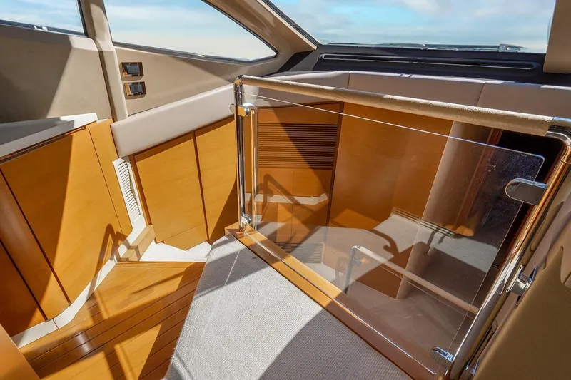 Elena I Yacht Photos Pics Interior of 2013 Azimut 64 yacht with wooden finishes and glass door.