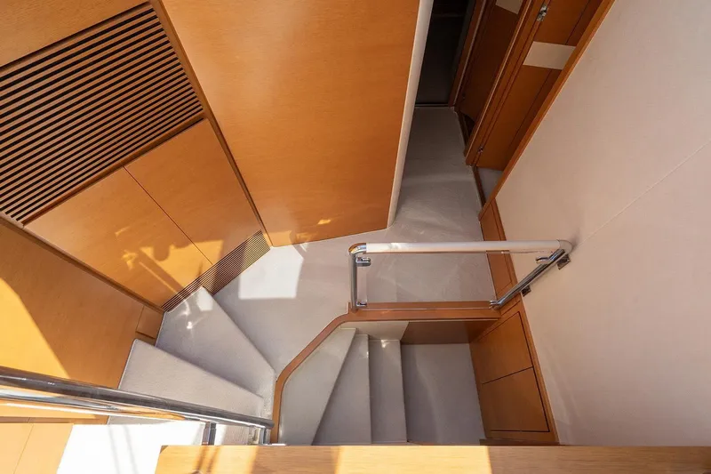 Elena I Yacht Photos Pics Interior staircase of 2013 Azimut 64 yacht with wooden finish and modern design.