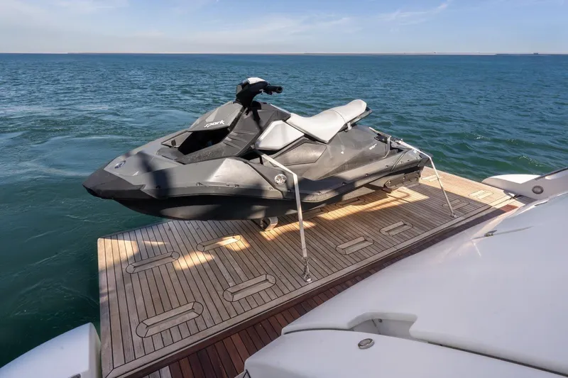Elena I Yacht Photos Pics Jet ski on Azimut 64 yacht's deck, 2013 model, floating on calm sea.