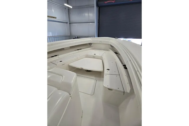  Yacht Photos Pics 2020 Regulator 41 boat interior with white seating and table in a storage facility.