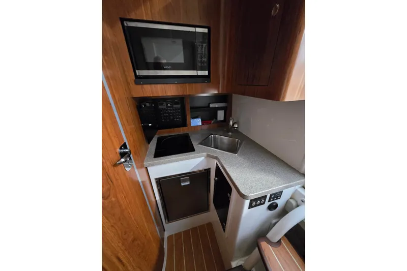  Yacht Photos Pics 2020 Regulator 41 boat interior with kitchenette, featuring microwave, sink, and compact design.