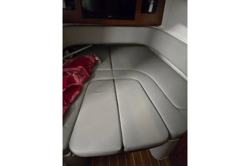  Yacht Photos Pics 2020 Regulator 41 boat cabin interior with cushioned seating and red blanket.
