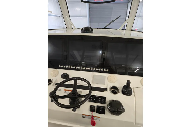  Yacht Photos Pics 2020 Regulator 41 boat dashboard with steering wheel and navigation screens.