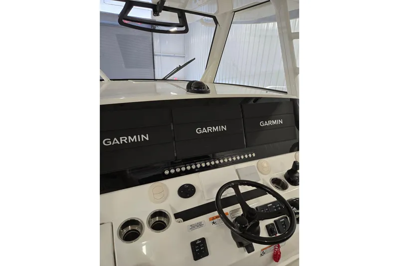 Yacht Photos Pics 2020 Regulator 41 boat dashboard with Garmin navigation displays and steering wheel.