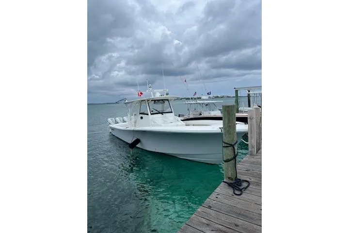  Yacht Photos Pics 2020 Regulator 41 boat docked on a cloudy day, turquoise water.