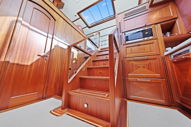 Bebe Deux Yacht Photos Pics Luxurious wooden interior of 2023 Vicem 65 Classic yacht with staircase and cabinetry.