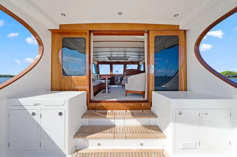 Bebe Deux Yacht Photos Pics Luxurious 2023 Vicem 65 Classic yacht interior with elegant wood finishes and spacious seating.