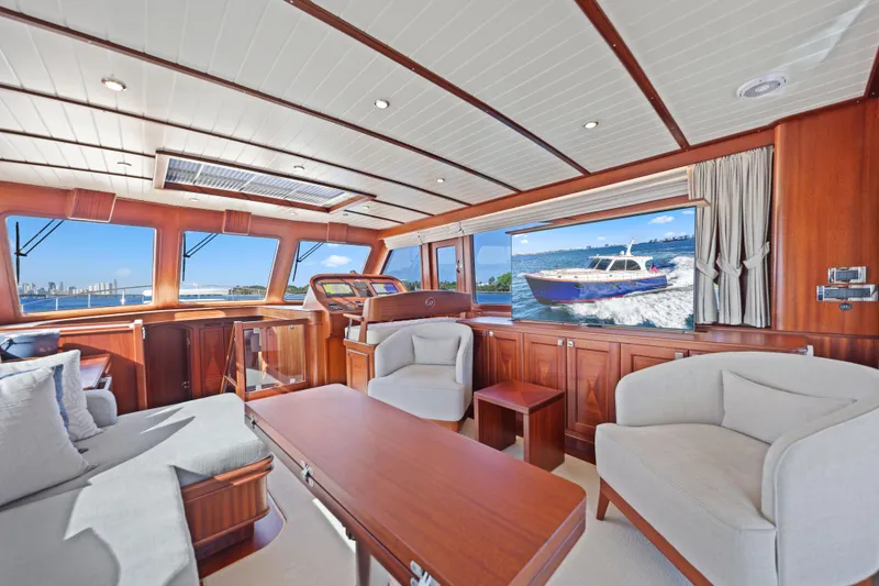 Bebe Deux Yacht Photos Pics Luxurious interior of 2023 Vicem 65 Classic yacht with elegant wood finish and comfortable seating.