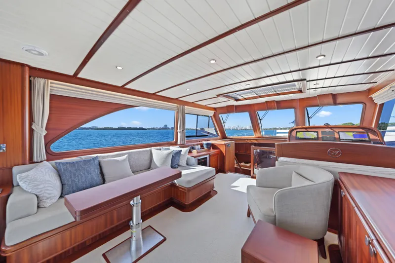 Bebe Deux Yacht Photos Pics Luxurious interior of 2023 Vicem 65 Classic yacht with elegant wood finishes and ocean view.