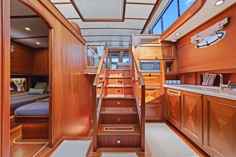 Bebe Deux Yacht Photos Pics Luxurious interior of 2023 Vicem 65 Classic yacht with wooden finishes and modern amenities.