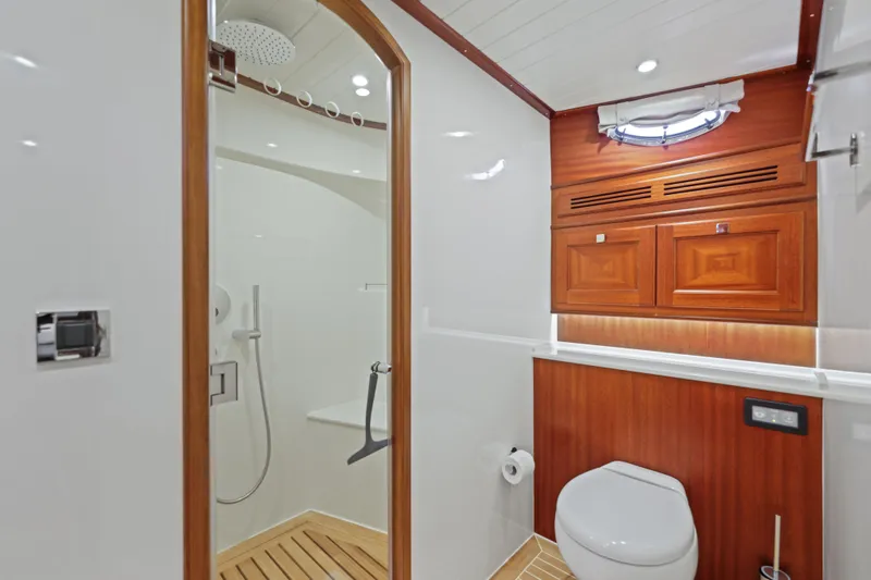 Bebe Deux Yacht Photos Pics Luxurious bathroom in 2023 Vicem 65 Classic yacht with wooden accents and modern fixtures.
