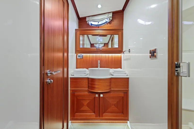 Bebe Deux Yacht Photos Pics Luxurious bathroom interior of 2023 Vicem 65 Classic yacht with wooden cabinetry and modern fixtures.