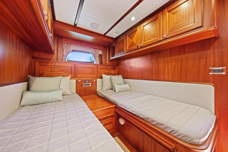 Bebe Deux Yacht Photos Pics Luxurious 2023 Vicem 65 Classic yacht cabin with twin beds and elegant wood finish.