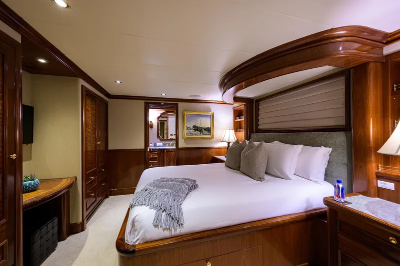 Excellence Yacht Photos Pics Luxurious bedroom interior on 2010 Richmond Yachts 150, featuring elegant wood finishes and cozy bedding.