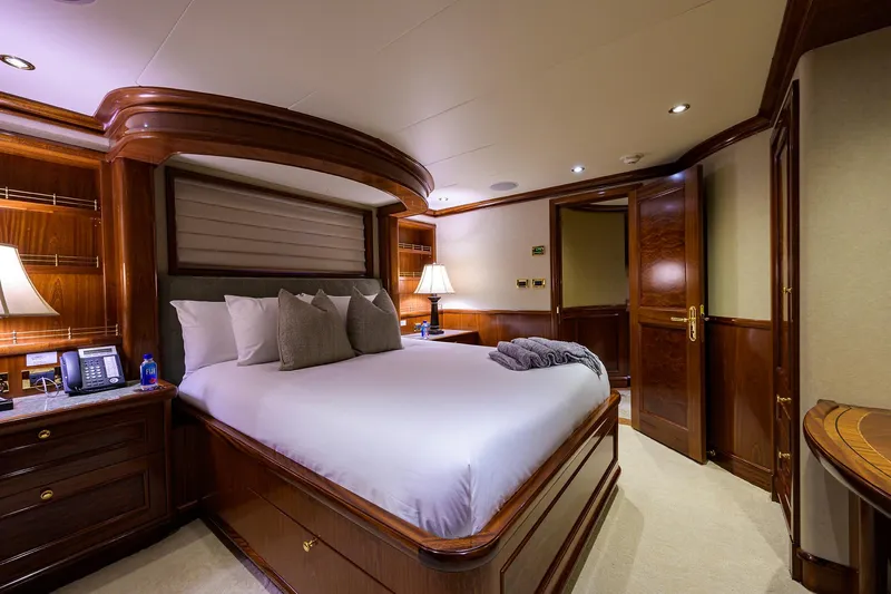 Excellence Yacht Photos Pics Luxurious bedroom interior on 2010 Richmond Yachts 150, featuring elegant wood finishes and ambient lighting.