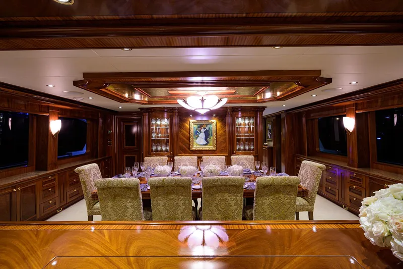 Excellence Yacht Photos Pics Luxurious dining room on 2010 Richmond Yachts 150, featuring elegant wood paneling and plush seating.