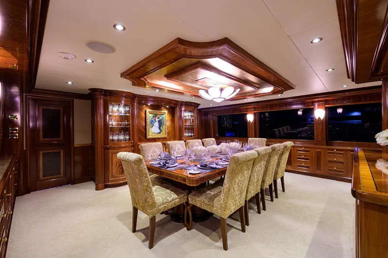 Excellence Yacht Photos Pics Luxurious dining room on 2010 Richmond Yachts 150, featuring elegant wood paneling and plush seating.