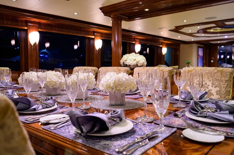 Excellence Yacht Photos Pics Luxurious dining setup on 2010 Richmond Yachts 150, featuring elegant tableware and floral centerpieces.